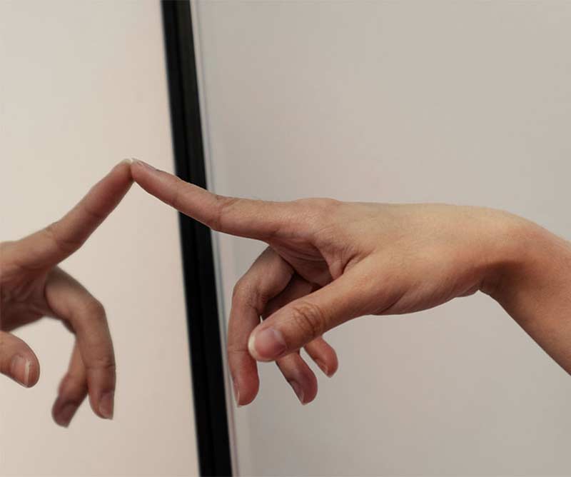 Hands interacting with touchscreen