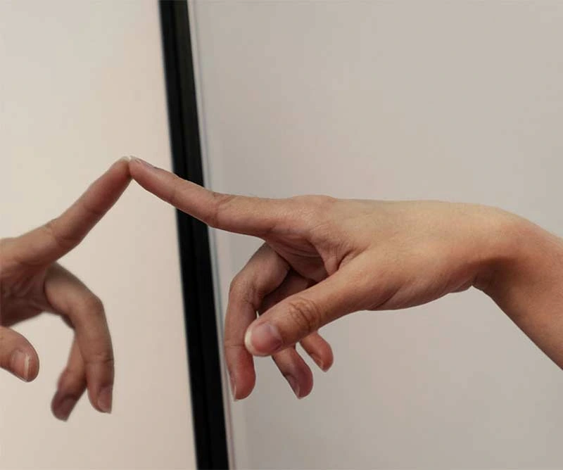 Hands interacting with touchscreen